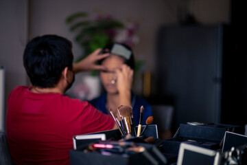selective focus Make-up converter on makeup artist's table with lots of makeup artist tools. blur background makeup artist doing makeup beautiful girl There is space for text.