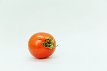 One red tomato on a white background