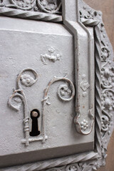 Vintage lock panel on door. Aged gate to medieval castle. Keyhole on old wooden door. Grunge security panel. Old ornate entrance door. Retro house security and safety system.