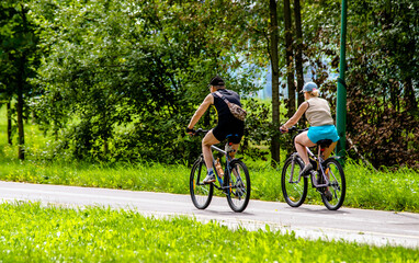 Cyclists ride on the bike path in the city Park
