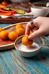 fried cheese balls served with sauce to the main course