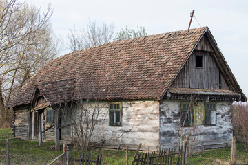 Fototapeta na wymiar Sunja, Croatia, 05,04,2021: Abandoned traditional old wooden house.  