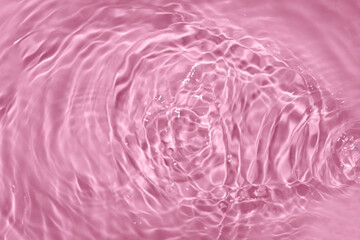 Circles on water. Pink round shadows. Blurred background made with water and light in monochrome. Pureness and freshness concept.