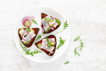 Sandwiches with salted herring fillet and beetroot pate. Top view, overhead