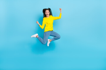 Full body photo of cool young brunette lady jump yell wear shirt jeans shoes isolated on blue background