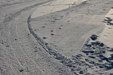 traces of snowmobiles in an arc and straight. compresses crushes, mills layers of snow and...
