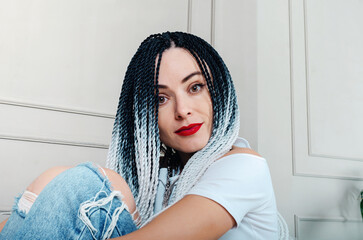 Portrait of a beautiful woman with dreadlocks. Red lipstick. Romantic look.