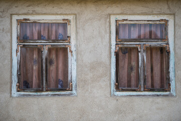 Fototapeta na wymiar Rustic style aged window in rural home wall.