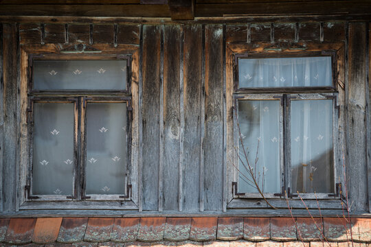Rustic style aged window in rural home wall.