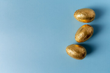 Chocolate eggs on a blue background. Space for text.