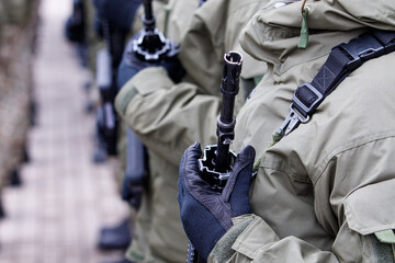 Lithuanian NATO soldier holding gun. Close up shot of soldier holding gun. Ukraine and Russia...