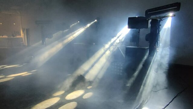 Scenic spotlights and smoke working machine in the club