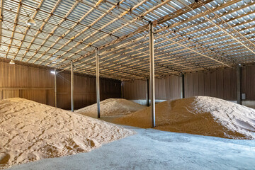 Piles of wheat grains at mill storage or grain elevator. The main commodity group in the food markets.