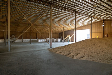 Piles of wheat grains at mill storage or grain elevator. The main commodity group in the food markets. - 487595415