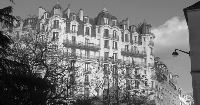 View of a building with typical historic architecture in black and white in the 5th district (5eme arrondissement), Paris, France. 4K video.