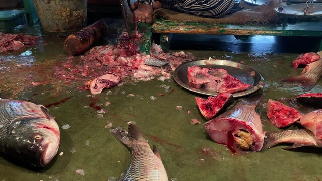 Kolkata: Unknown people selling and cutting fish at a street market in the Jadu babu bazaar area of Kolkata, West Bengal, India