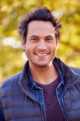 Portrait Of Smiling Man Outdoors Relaxing In Autumn Park