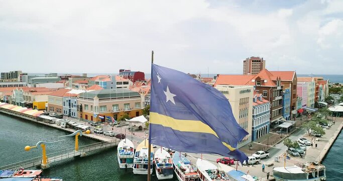 Curaçao flag at williamstrad city. 
aerial view of  Willemstad is the capital city of Curaçao, a Dutch Caribbean island.