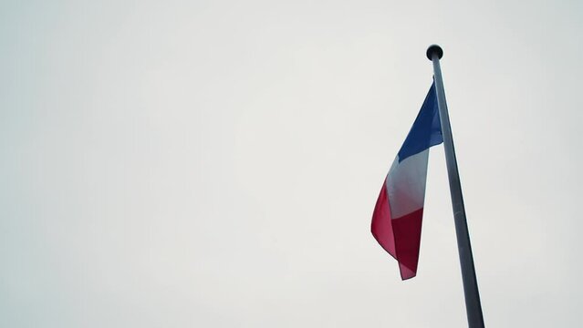 French flag waving at sunset in Paris, France