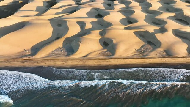 Sand dunes meet the Atlantic Ocean. Top view of Maspalomas sand dunes.