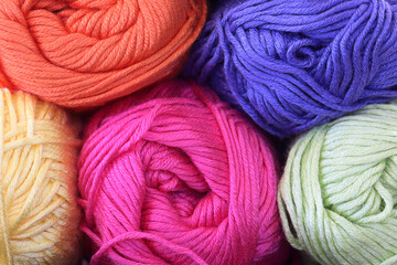 Close up of colorful yarn. Orange, purple, yellow, pink, and green yarn