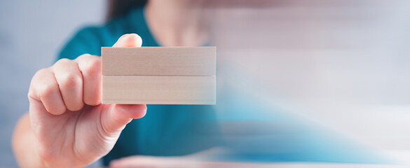 young woman holding wooden rectangles