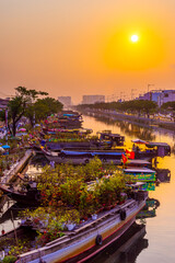 Springtime in Saigon, boat on canal, transport spring flower for Tet to Ben Binh Dong open air...