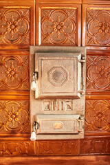 The furnace and brown tiles on the stove surface. Texture