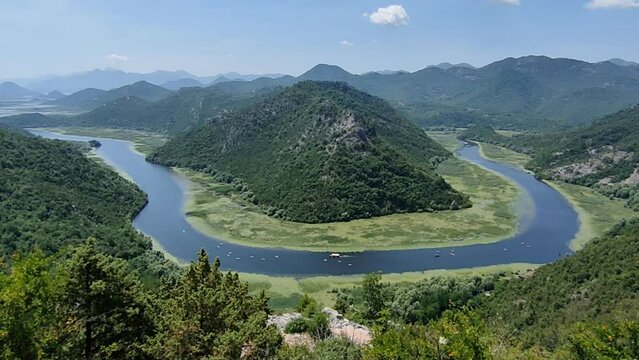 View of the river Crnojevica, Lake Skadar, Montenegro. A place where the river bends around the green mountain.