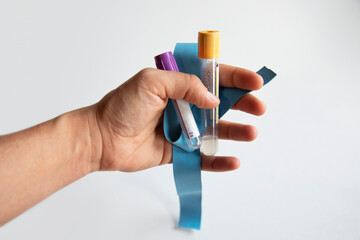 woman's hand with blood collection tubes on white background