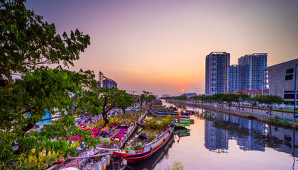 Springtime in Saigon, boat on canal, transport spring flower for Tet to Ben Binh Dong open air market, Vietnamese happy with Lunar New Year, Vietnam © CravenA