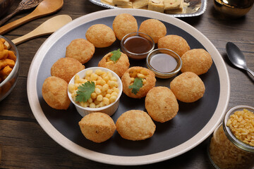 verity of indian bengali street food tea time snacks onion pakoda crunchy spicy lentils moong dal...