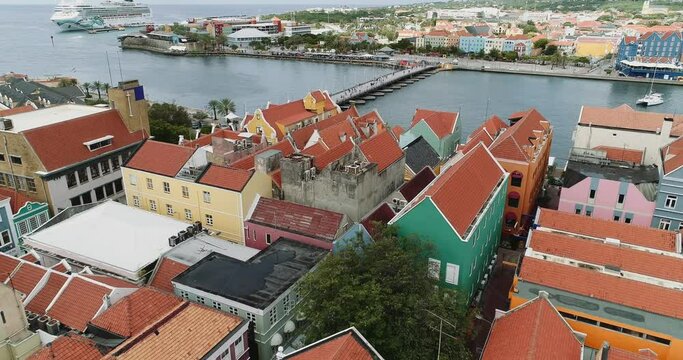Willemstad is the capital city of Curaçao, a Dutch Caribbean island. aerial view  features brightly painted colonial buildings and colorful roofs. 
At he other side of outrobanda.