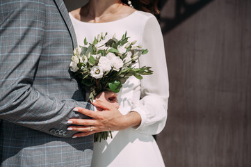 The hands of the newlyweds gently touch each other 3823.
