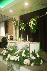 The main table of the newlyweds for the wedding is decorated with whit