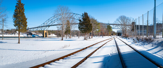 Snow on the railroads. Panoramic vista under Sagamore Bridge on Cape Cod, Massachusetts.
