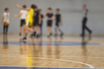 View of basketball court hall indoor venue with junior teenage school team playing in the...