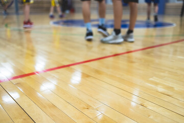 View of basketball court hall indoor venue with junior teenage school team playing in the...