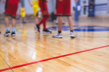 View of basketball court hall indoor venue with junior teenage school team playing in the background, basketball match game on arena stadium, team is blurred with copy space