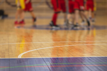 View of basketball court hall indoor venue with junior teenage school team playing in the...