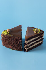 Homemade Chocolate Cake with Vanilla Cream on a Blue Background Decorated with Nuts Tasty Dessert Vertical