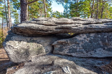 Autumn landscape with trees and rocks on top of a mountain against the sky