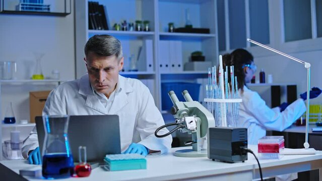 Nervous lab assistant noticing mistake in test results on laptop, negligence