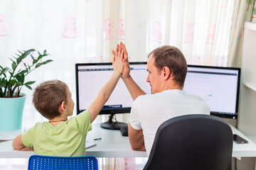 Obraz premium Father with kid trying to work from home during quarantine. Stay at home, work from home concept during coronavirus
