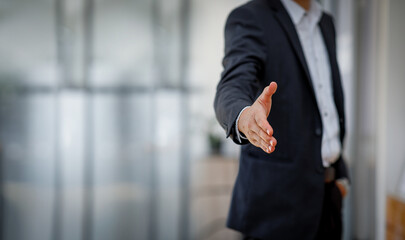 Businessman giving his hand for handshake to partner,businessman shake hand with partner to...