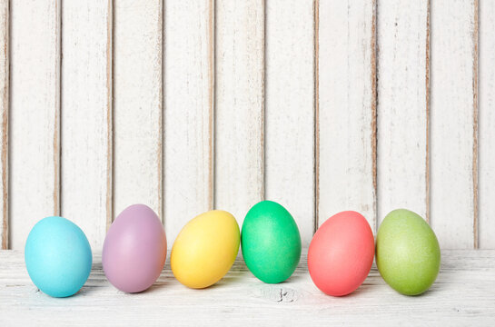 Colorful Easter eggs row on wood