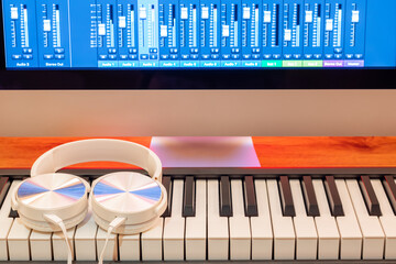 white headphone on midi keyboard. music production concept