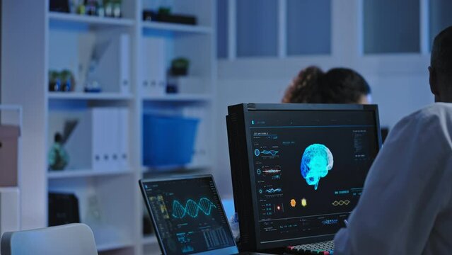 Neurosurgeon studying brain mri scan on computer, disease diagnostics, treatment