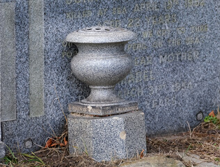 Composite material memorial urn on grave.
