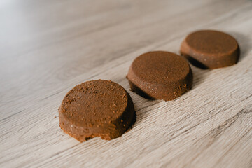 pressed ground coffee tablets lie on the table